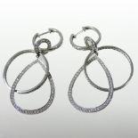 A pair of unmarked diamond earrings,