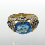 A modern 18 carat gold blue topaz ring, with pave set sapphire and diamond set shoulders, size N, 6.