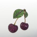 An 18 carat gold emerald, ruby and diamond set brooch, in the form of two cherries on a leaf,