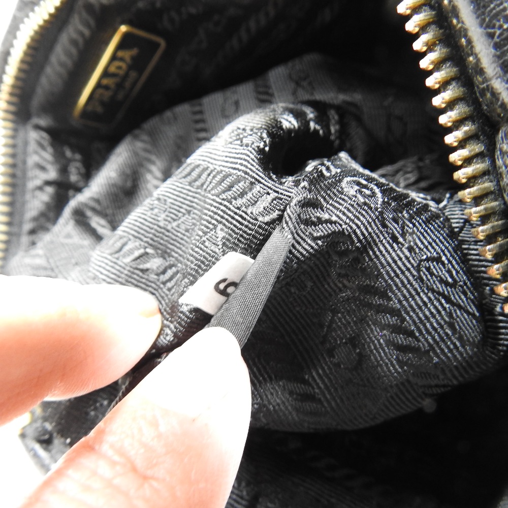 *Withdrawn* A Prada black leather clutch bag, 21cm, together with a Christian Dior cream clutch bag, - Image 7 of 34