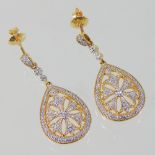 A pair of 22 carat gold and diamond pendant earrings, of pear shape, with a flower head design,