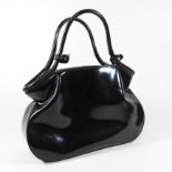 An Yves Saint Laurent black patent handbag, with a detachable inner compartment,