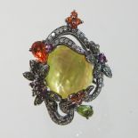 A modern 14 carat gold multi gem set designer ring, the central faceted stone,