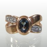 A 14 carat gold blue topaz and diamond ring, the central collet set stone,