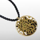 A Cartier 18 carat gold and black onyx 'Panthere de Cartier' pendant, decorated with a panther,