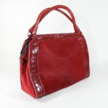 A Donna Karan red leather and suede handbag, with crocodile skin effect borders,