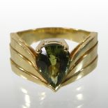 An 18 carat gold peridot single stone pear cut ring, with shaped shoulders, stamped EJ, size L,