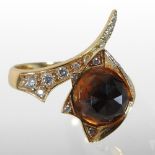 A Stephen Webster 14 carat gold citrine and diamond ring, the central facet cut stone,