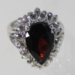 A 14 carat gold garnet and diamond cluster ring, the central pear cut stone,