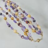 A JKa multi coloured stone triple strand bead necklace, with an 18 carat gold clasp,