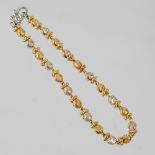 An 18 carat two colour textured gold bead bracelet, with a flower head clasp, 10.