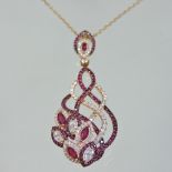 An Italian 18 carat rose gold, ruby and diamond pendant necklace, of entwined asymmetrical design,