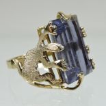 A 14 carat gold topaz ring, the central baguette cut stone, held by two reptiles, inscribed Vincent,