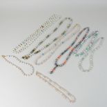 A collection of modern single strand bead necklaces, to include one with a 14 carat gold clasp,