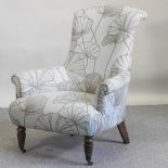 A modern floral upholstered armchair, on turned legs,