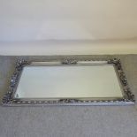 A silver painted framed wall mirror,