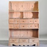 An antique pine bank of fourteen short drawers,