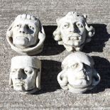 A set of four reconstituted stone wall mounted masks,