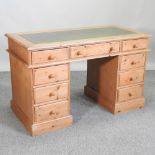 A pine pedestal desk, with an inset writing surface,