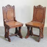 A pair of Victorian oak Gothic revival hall chairs,