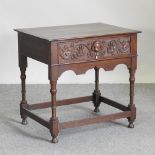 An early 20th century carved oak side table, containing a single drawer,