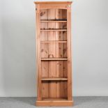 A modern pine narrow open bookcase,