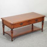 A reproduction coffee table, containing two drawers,