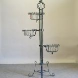 A green painted wrought iron three tier planter,