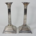A pair of silver table candlesticks, in the form of Corinthian columns, stamped Filled,