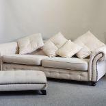 A large cream upholstered chesterfield style sofa, with loose cushions, 244cm,