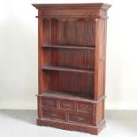 A hardwood standing bookcase, with drawers below,