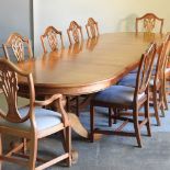 A yew wood triple pedestal dining table, with two additional leaves, 320 x 110cm overall,