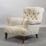 A Victorian blue and cream floral upholstered button back arm chair