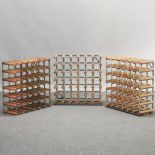 A wine rack, together with two others,