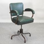 A mid 20th century industrial swivel armchair