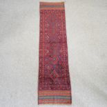 A Turkish woollen runner, with a row of five medallions, on a red ground,