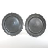 A pair of 18th century pewter chargers, each of circular shape, with a reeded shaped border,