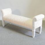 A cream upholstered and white painted window seat,