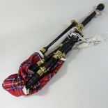 A modern set of bagpipes, together a collection of musical instruments, to include violins,