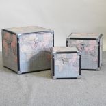 A set of three modern graduated trunks, with atlas decoration,