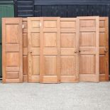 A collection of eight various pitch pine panelled interior doors