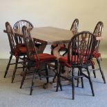 A set of four Ercol dark elm hoop back dining chairs,