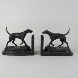A pair of modern bronze bookends, each in the form of a retriever dog, on a marble base,