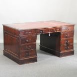 A reproduction pedestal desk,