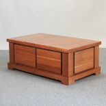 A cherrywood coffee table, with a sliding top,