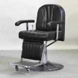 A black upholstered barber's chair
