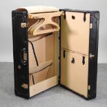 A vintage Italian black travel trunk, with a fitted interior,