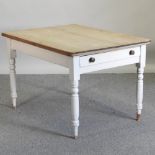 An antique pine and painted dining table,