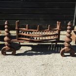 A large antique cast iron fire grate, of curved shape,