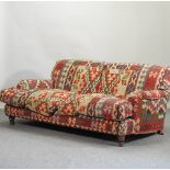 A red kelim upholstered sofa,